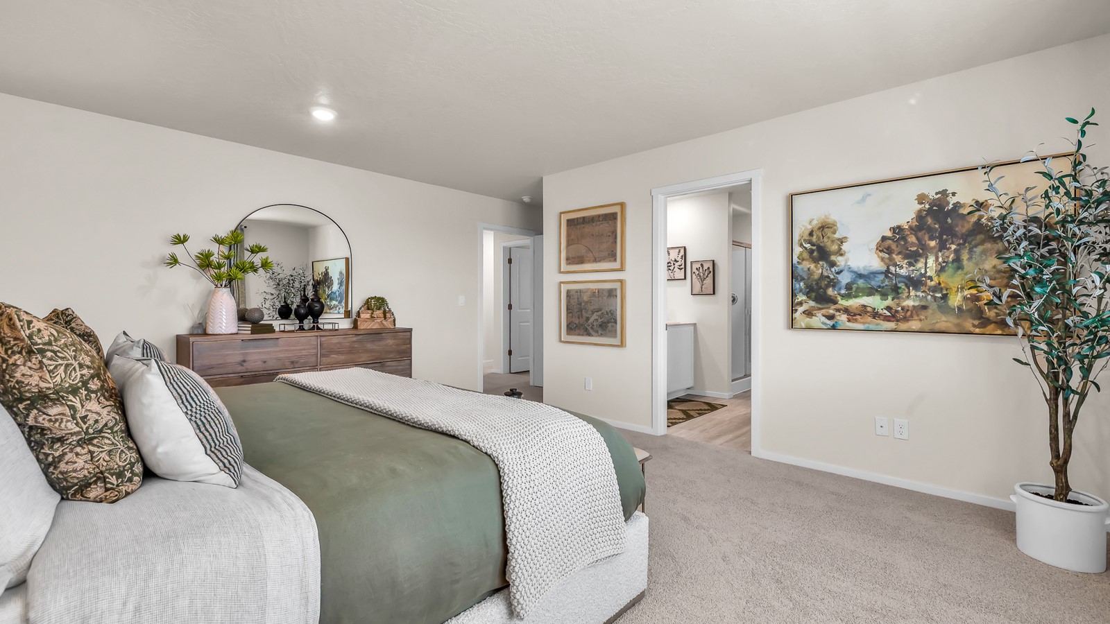 Primary bedroom with wall-to-wall carpet, a walk-in closet and an attached bathroom