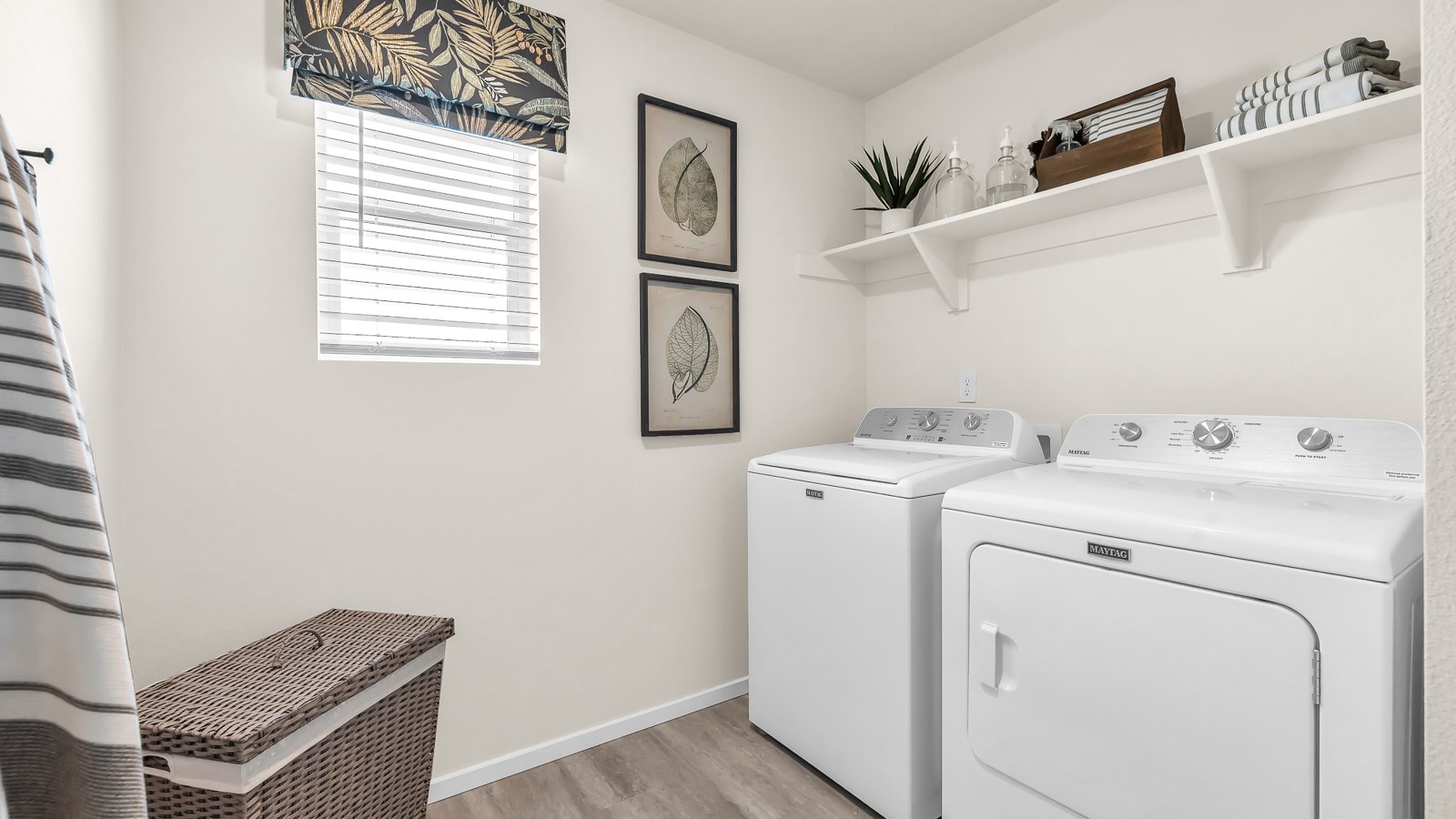 Laundry room with built-in shelves and washer and dryer hookups