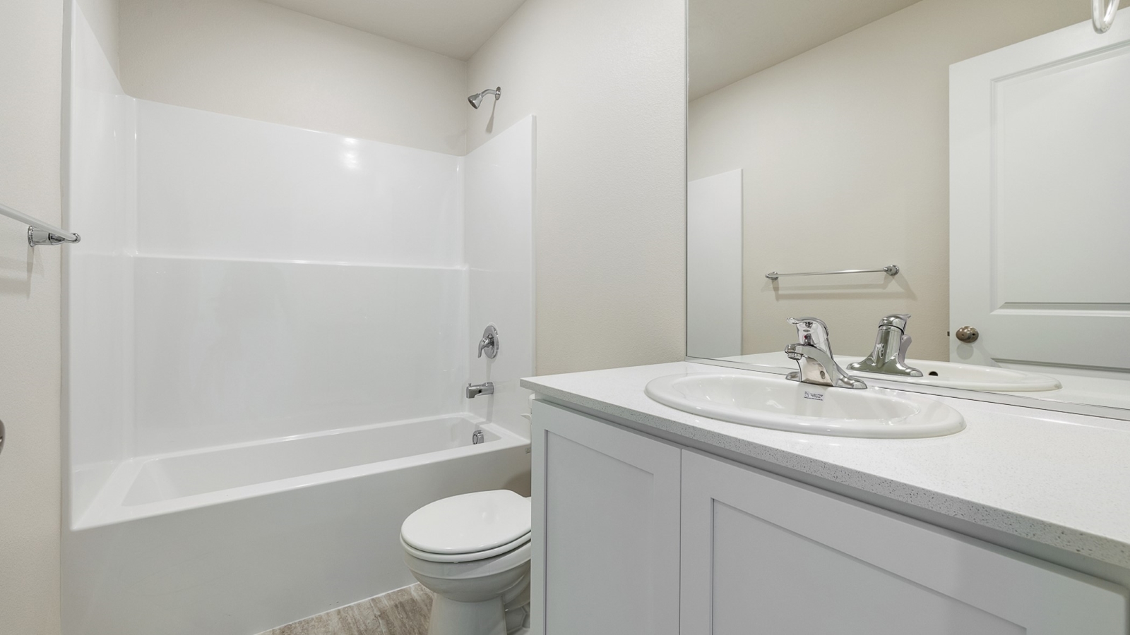 Hall bathroom with combination tub/shower and quartz counters