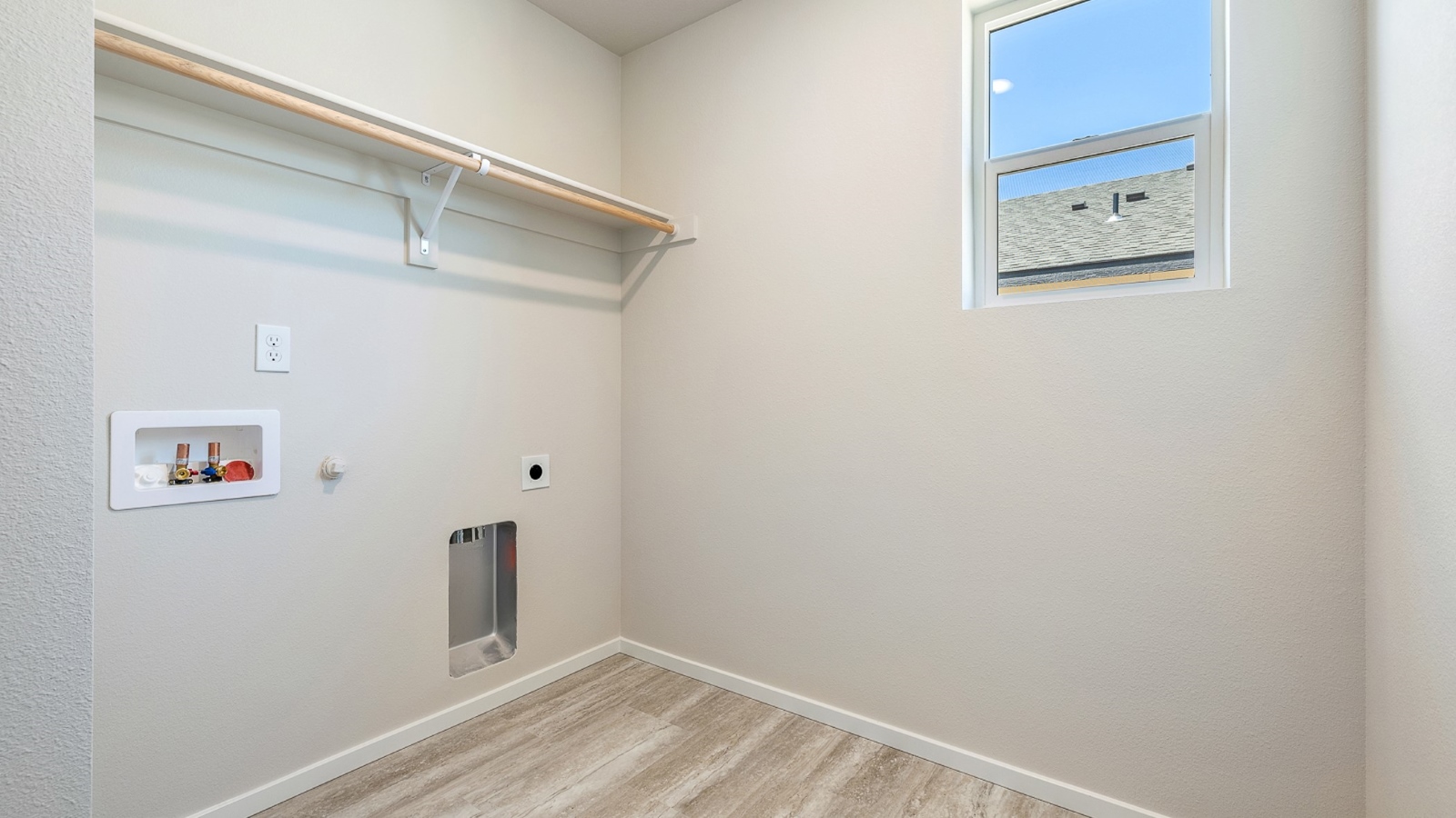 Laundry room with built-in shelves and washer and dryer hookups