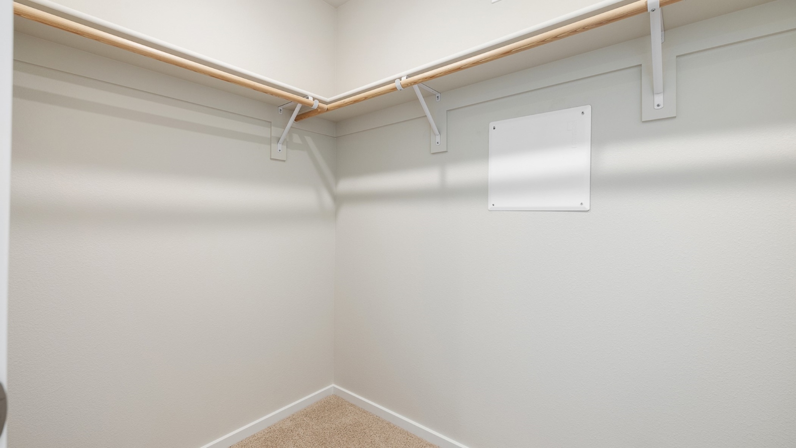 Primary bedroom walk-in closet with built-in shelves