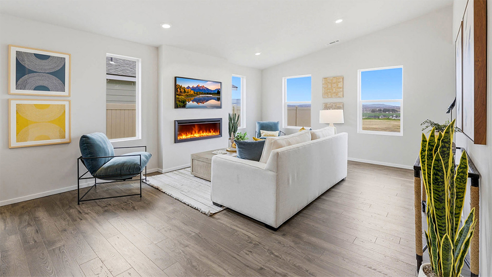 Great room with laminate flooring and an electric fireplace and vaulted ceilings