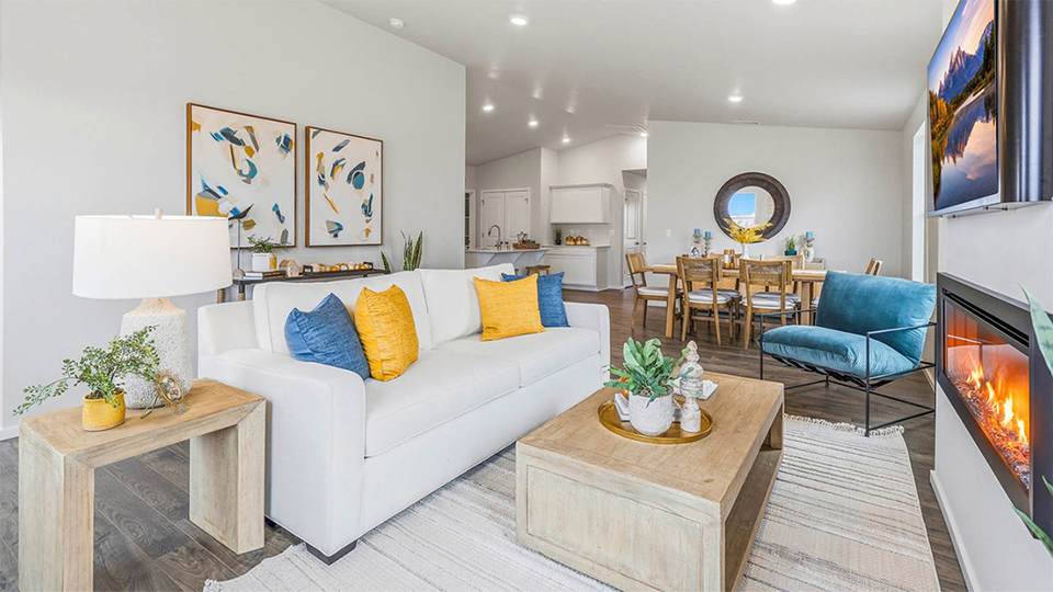 Great room with laminate flooring and an electric fireplace and vaulted ceilings