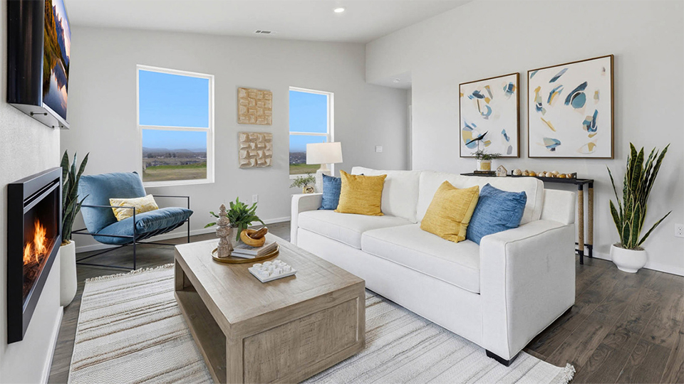 Great room with laminate flooring and an electric fireplace and vaulted ceilings