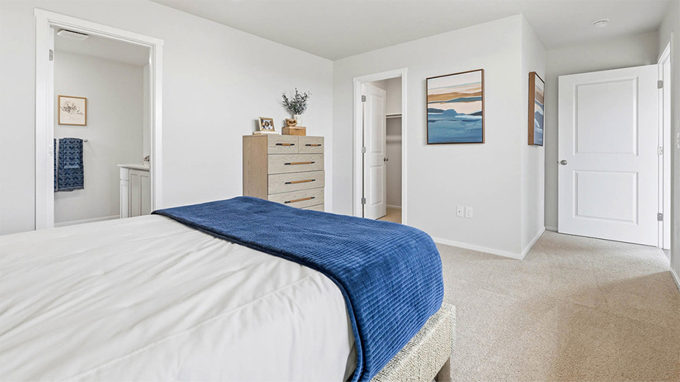 Primary bedroom with wall-to-wall carpet, a walk-in closet and an attached bathroom
