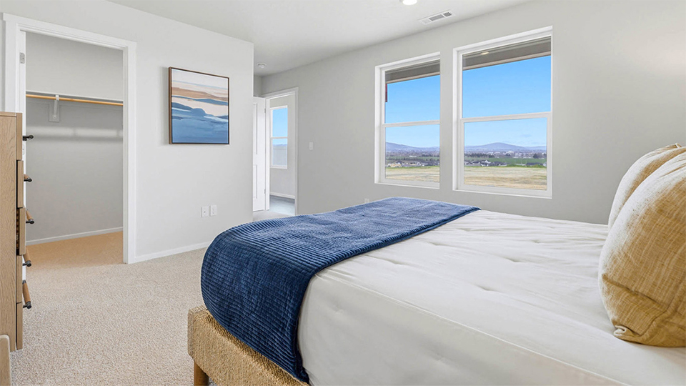 Primary bedroom with wall-to-wall carpet, a walk-in closet and an attached bathroom