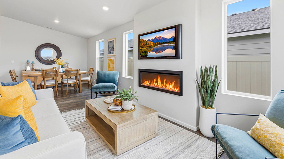 Great room with laminate flooring and an electric fireplace and vaulted ceilings