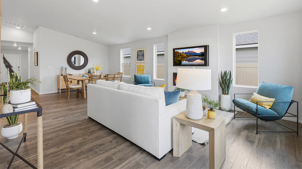 Great room with laminate flooring and an electric fireplace and vaulted ceilings