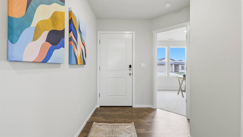 Entryway with a coat closet and laminate flooring