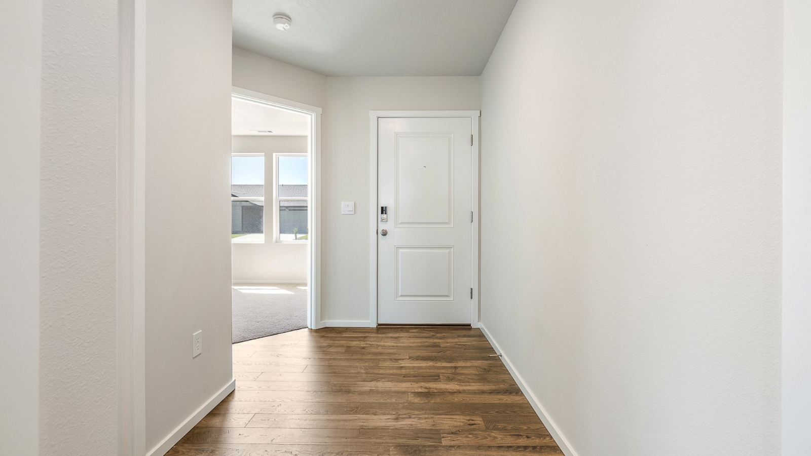 Entryway with a coat closet and laminate flooring