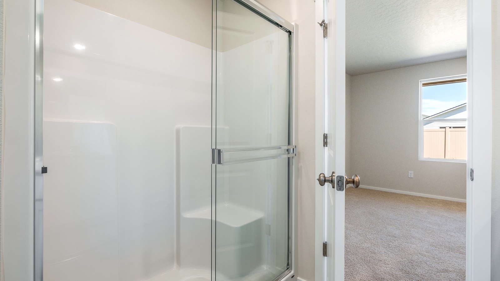 Primary bathroom with quartz counters and a walk-in shower