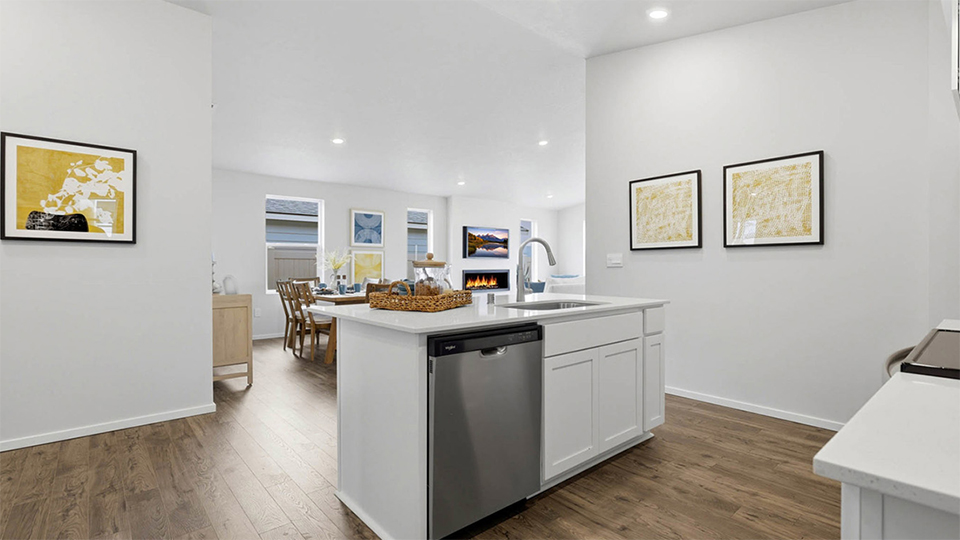 Kitchen with shaker cabinets, quartz counters, stainless steel appliances, pantry, and an island with a breakfast bar