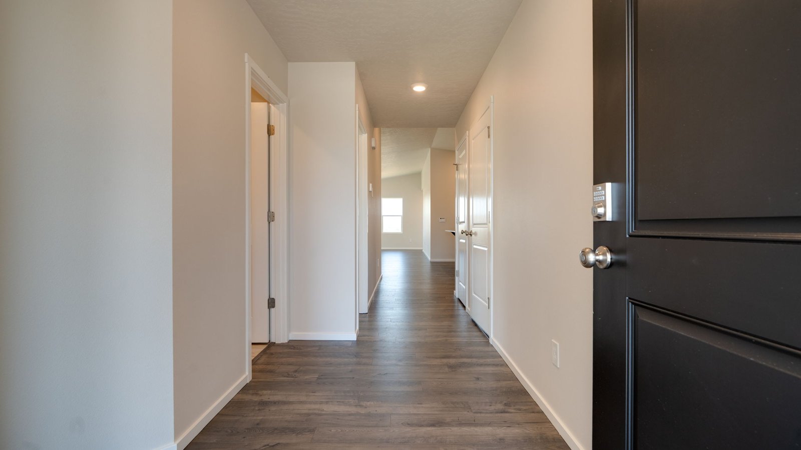 Entryway with a coat closet and laminate flooring