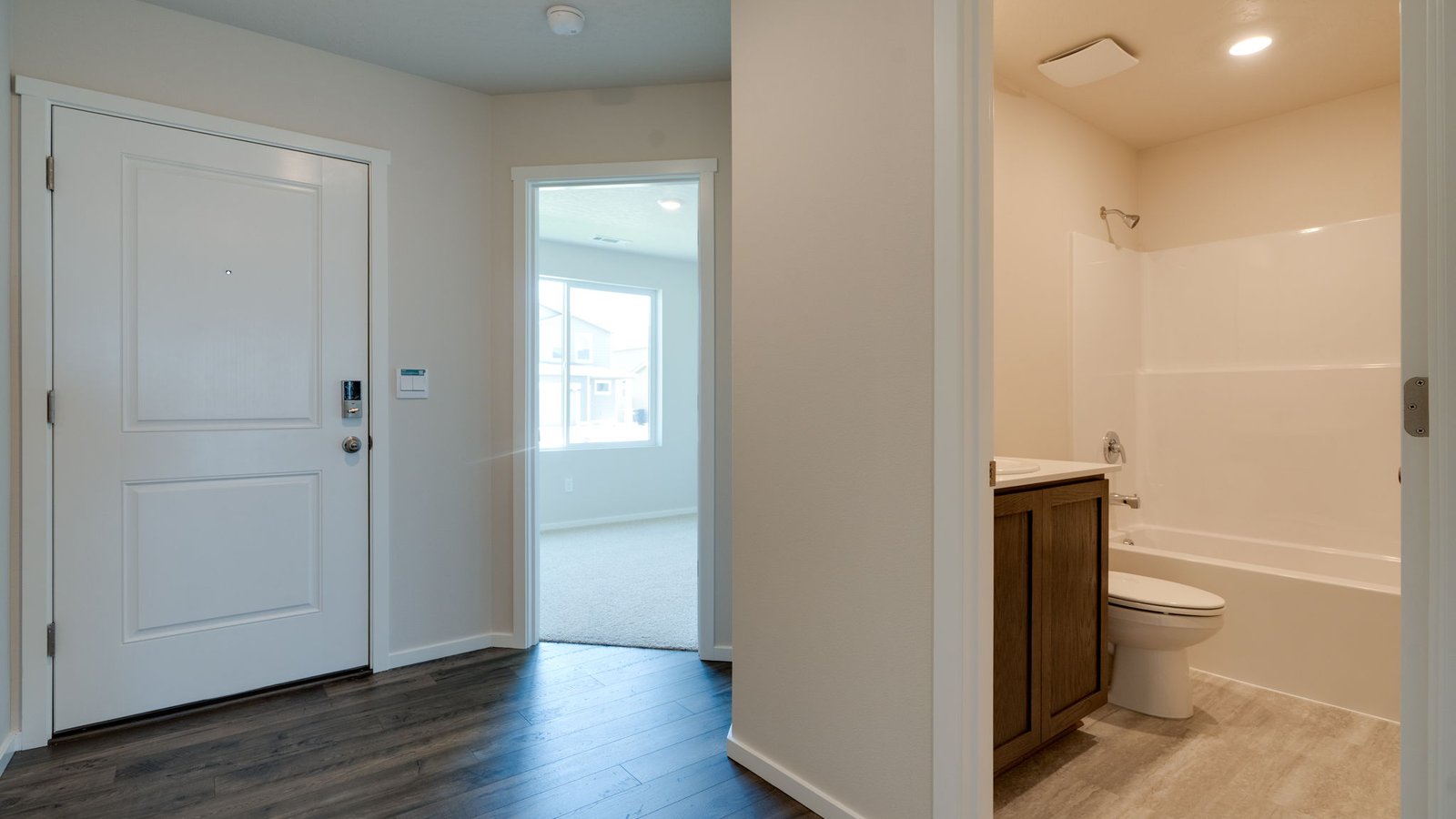 Entryway with a coat closet and laminate flooring