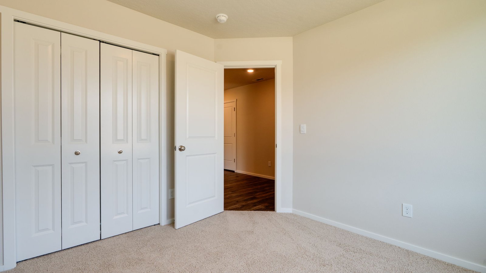 Bedroom with wall-to-wall carpet and a closet