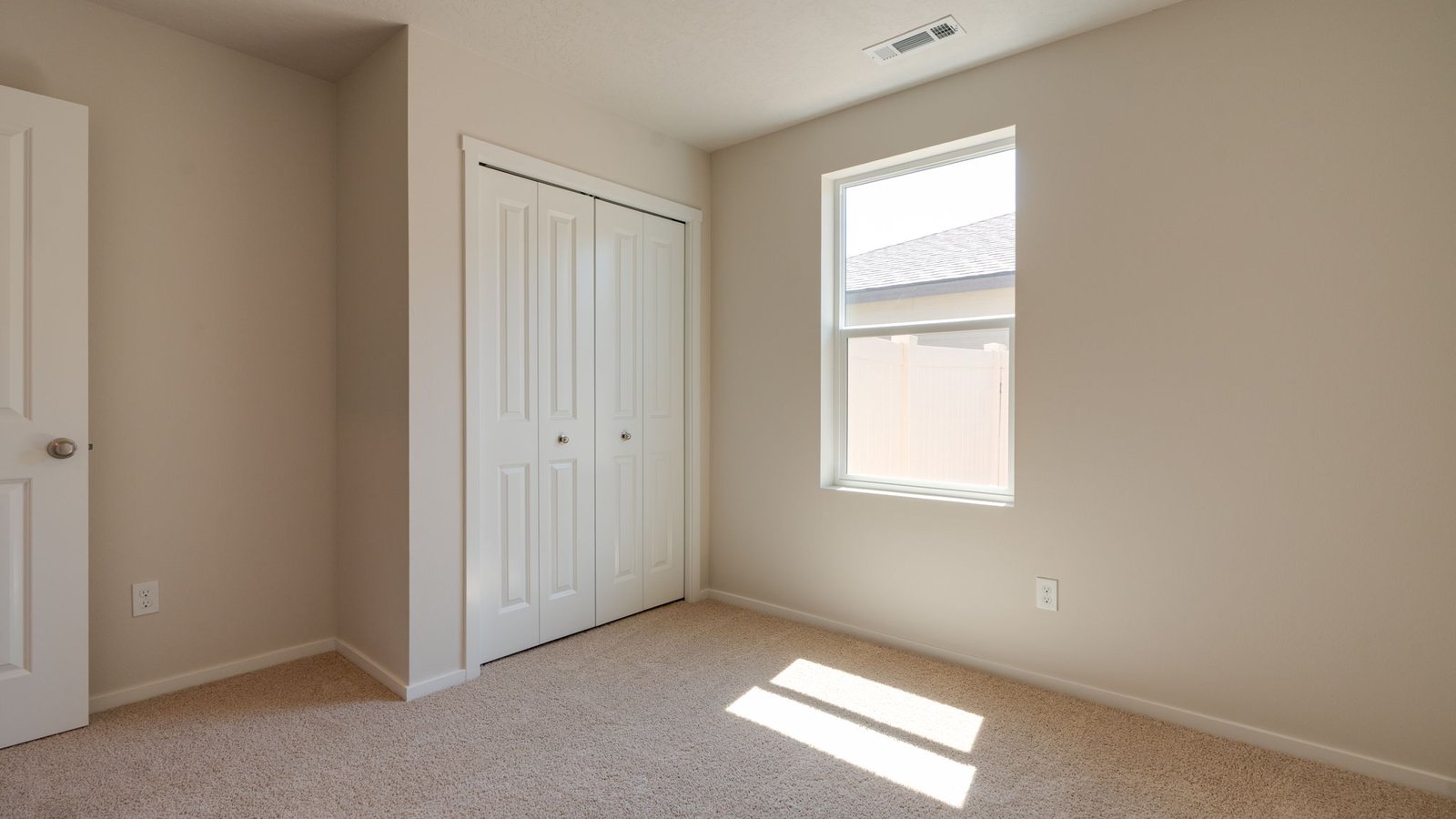 Bedroom with wall-to-wall carpet and a closet