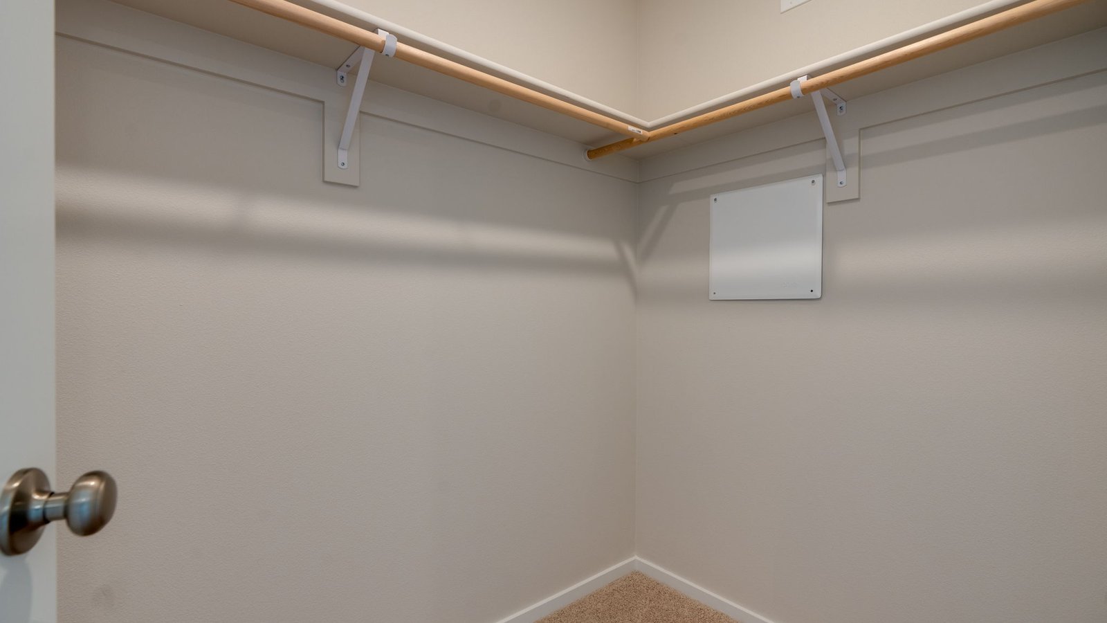 Primary bedroom walk-in closet with built-in shelves