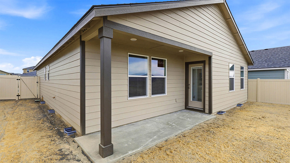 backyard with vinyl plank fence and covered patio