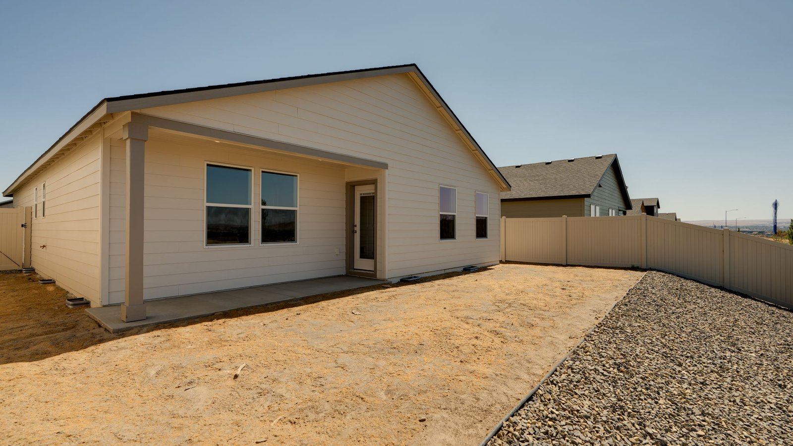 backyard with vinyl plank fence and covered patio