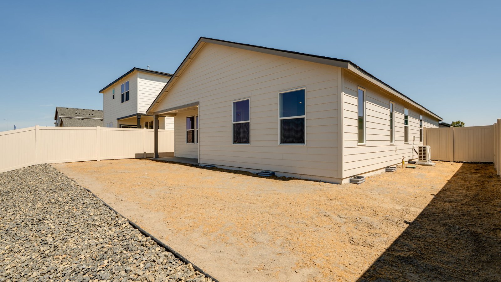 backyard with vinyl plank fence and covered patio