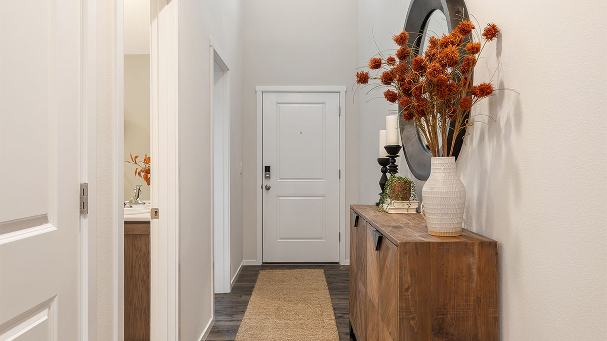 Entryway with a coat closet and laminate flooring