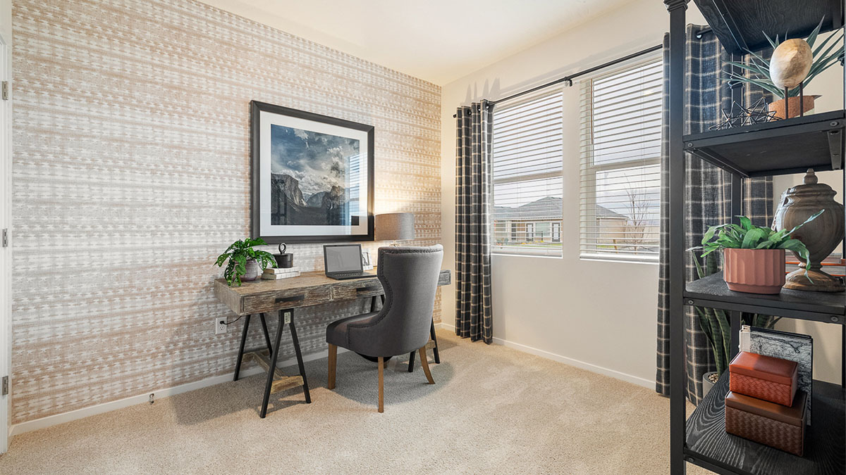 Bedroom staged as an office with wall-to-wall carpet and a closet