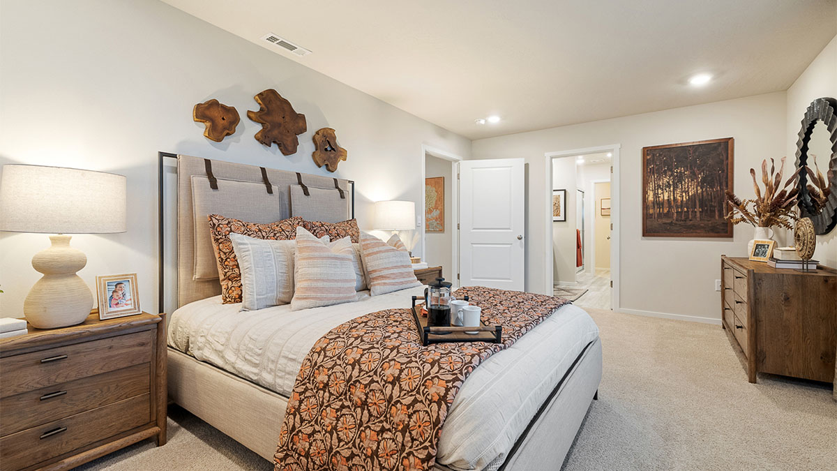 Primary bedroom with wall-to-wall carpet, a walk-in closet and an attached bathroom