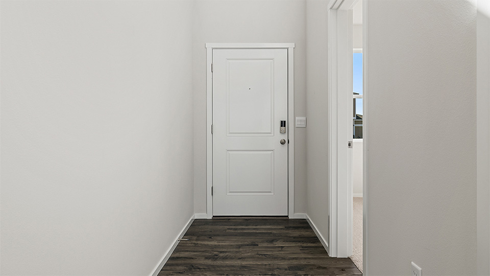 Entryway with a coat closet and laminate flooring