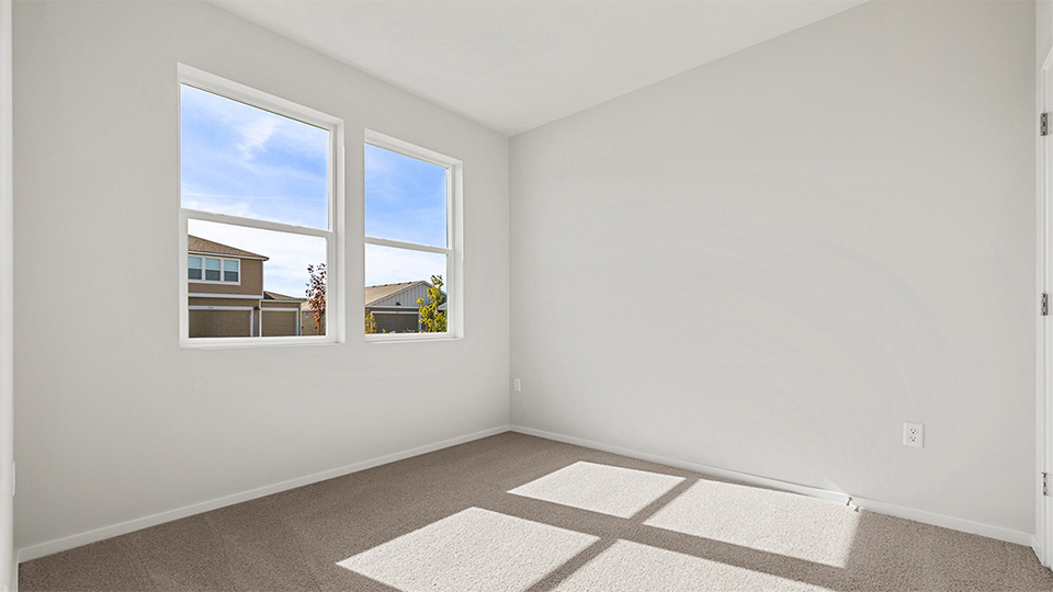 Bedroom with wall-to-wall carpet and a closet