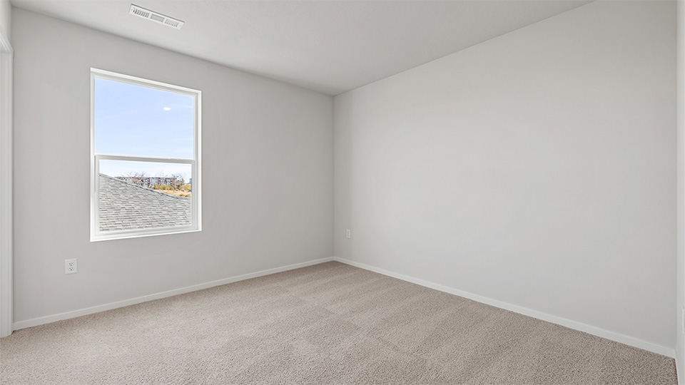 Bedroom with wall-to-wall carpet and a closet