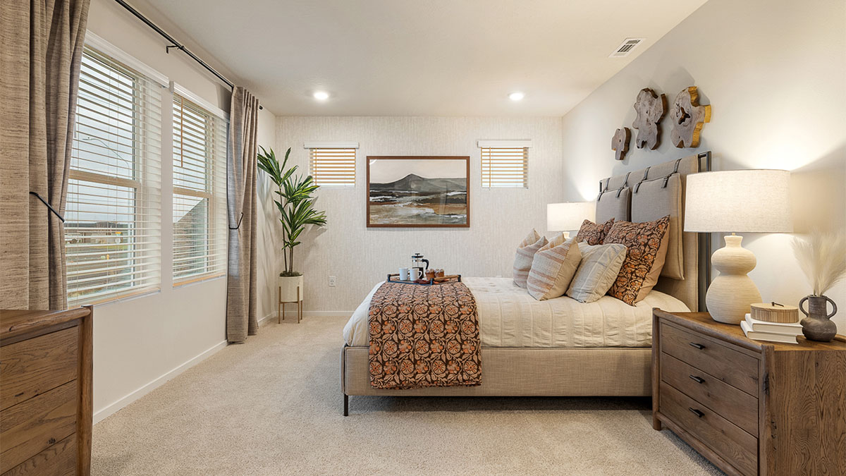 Primary bedroom with wall-to-wall carpet, a walk-in closet and an attached bathroom