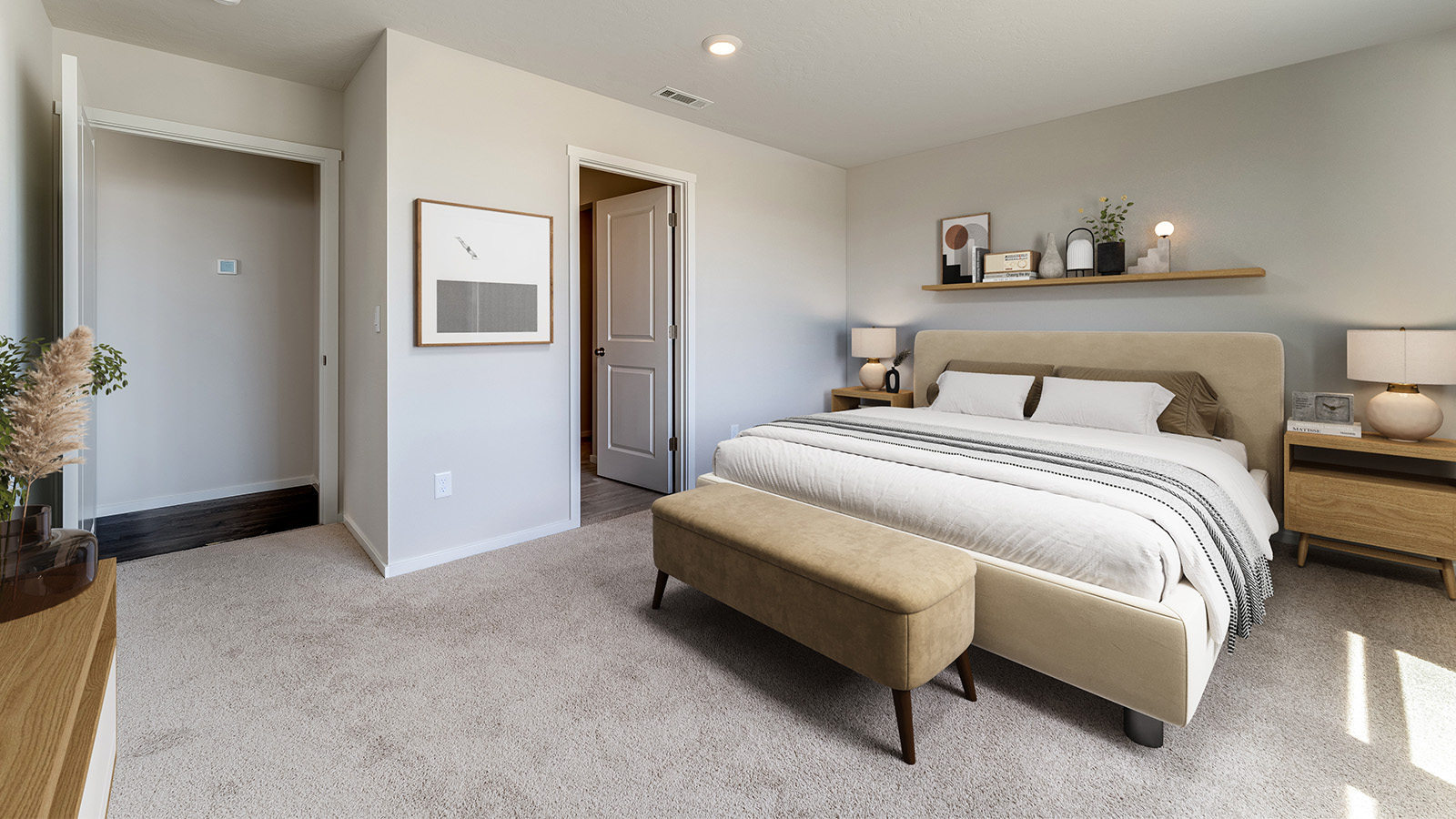 Primary bedroom with wall-to-wall carpet, a walk-in closet and an attached bathroom
