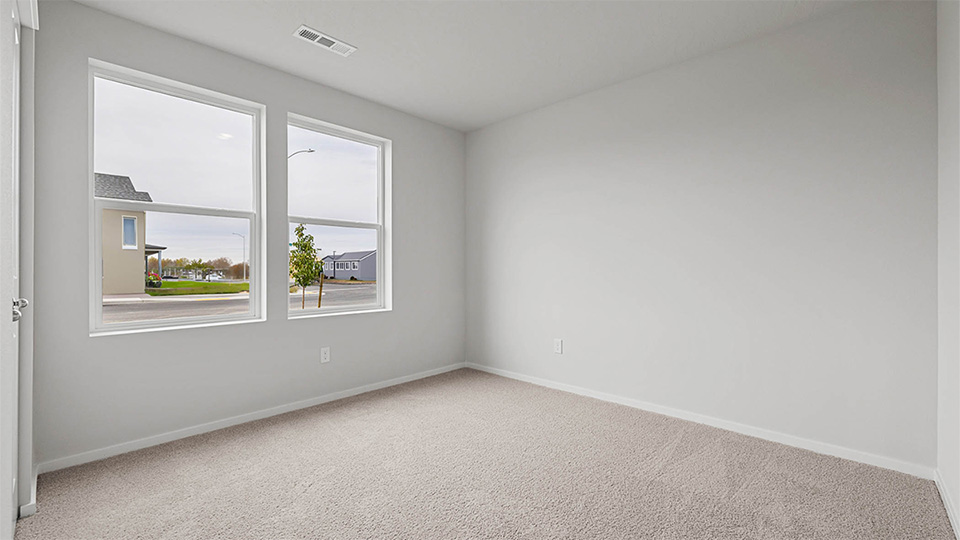 Bedroom with wall-to-wall carpet and a closet