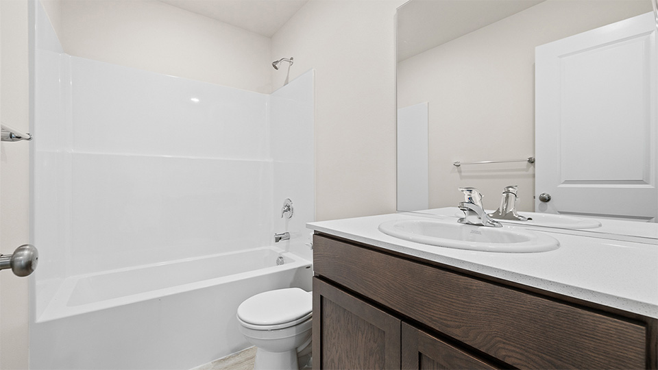 Hall bathroom with combination tub/shower and quartz counters