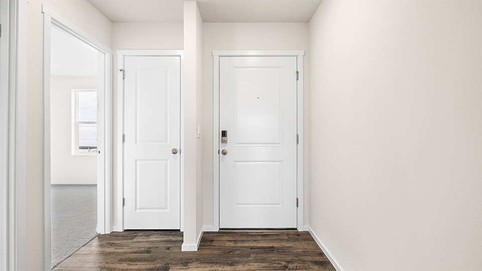 Entryway with a coat closet and laminate flooring