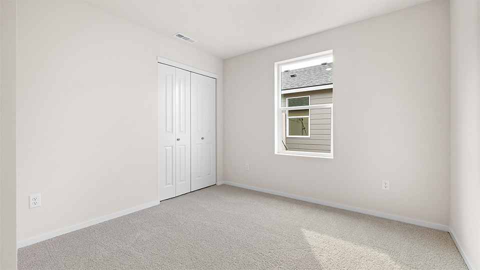 Bedroom with wall-to-wall carpet and a closet