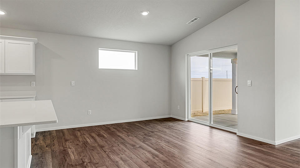 Dining area with a sliding glass door to a fenced backyard