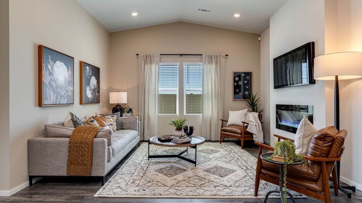 Great room with laminate flooring and an electric fireplace and vaulted ceilings