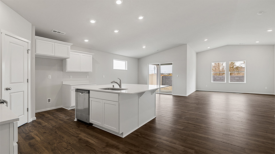 Kitchen with shaker cabinets, quartz counters, stainless steel appliances, pantry, and an island with a breakfast bar