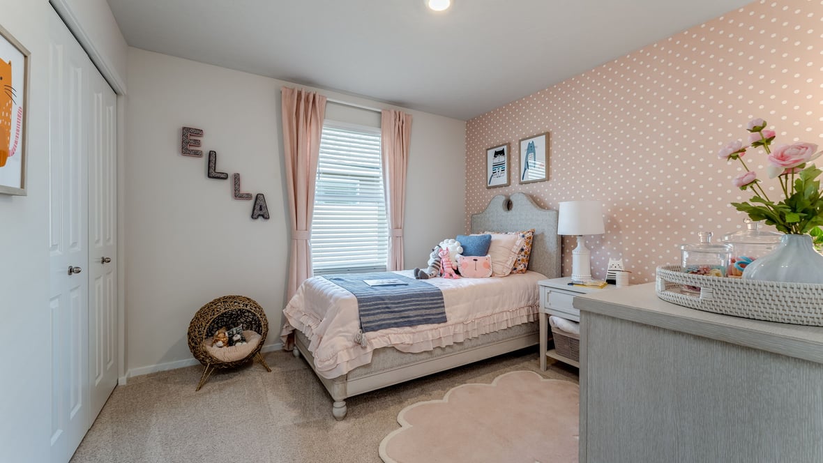 Bedroom with wall-to-wall carpet and a closet