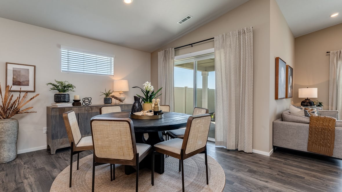 great room with an electric fireplace, vaulted ceilings, and premium laminate flooring