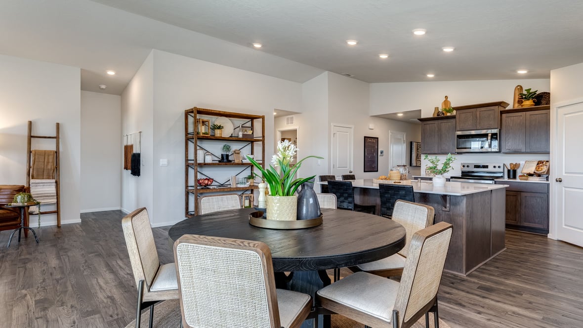 Kitchen with shaker cabinets, quartz counters, stainless steel appliances, pantry, and an island with a breakfast bar