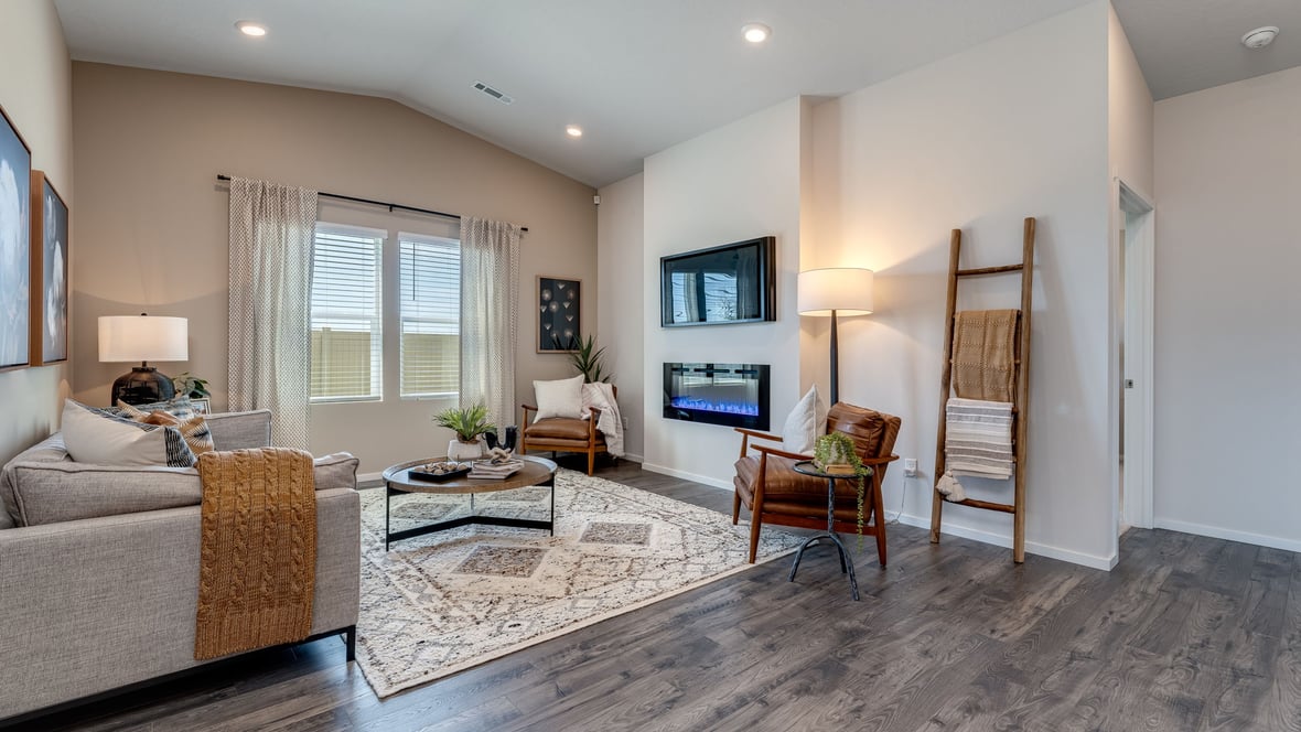 Great room with laminate flooring and an electric fireplace and vaulted ceilings