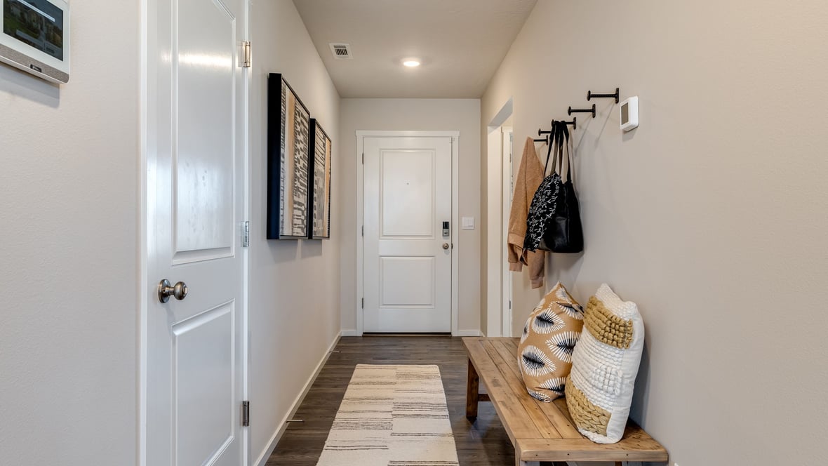 Entryway with a coat closet and laminate flooring
