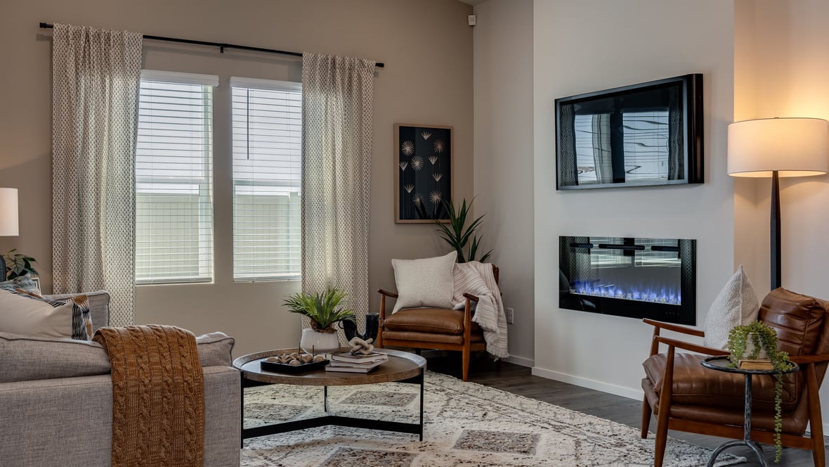 Great room with laminate flooring and an electric fireplace and vaulted ceilings