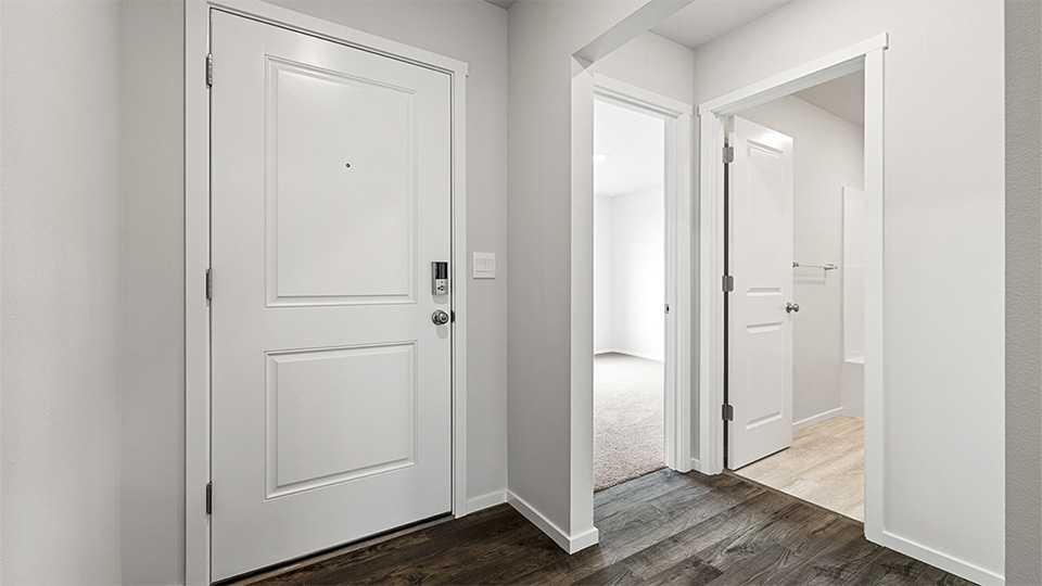 Entryway with a coat closet and laminate flooring