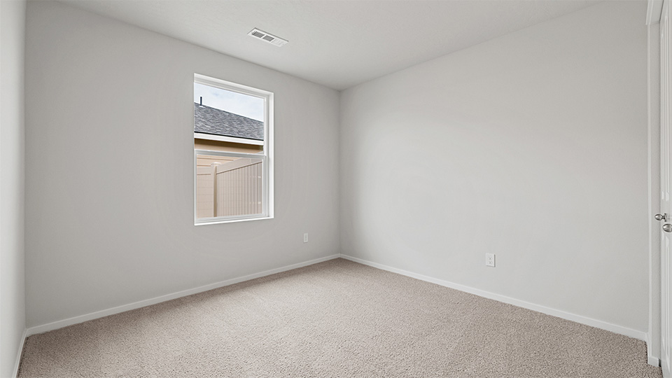 Bedroom with wall-to-wall carpet and a closet