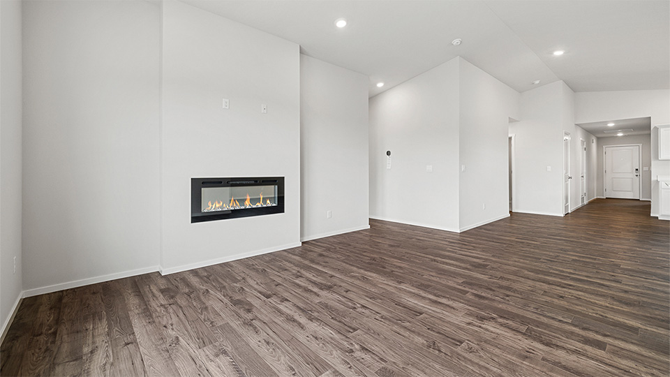 Great room with laminate flooring and an electric fireplace and vaulted ceilings