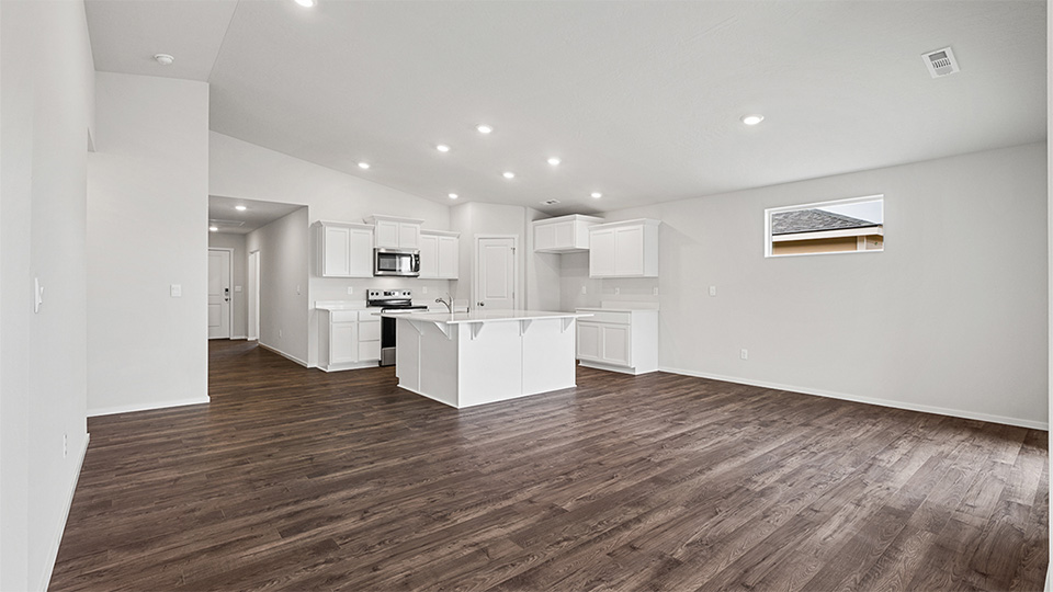 Great room with laminate flooring and an electric fireplace and vaulted ceilings