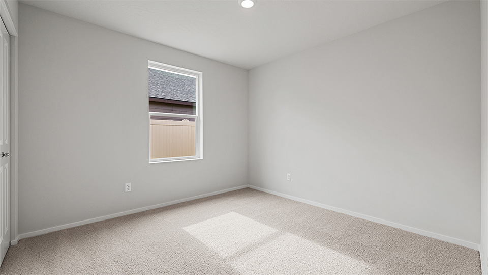 Bedroom with wall-to-wall carpet and a closet